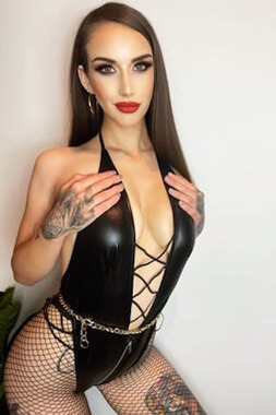 sexy female stripper with smouldering looks kneeling in bra and panties